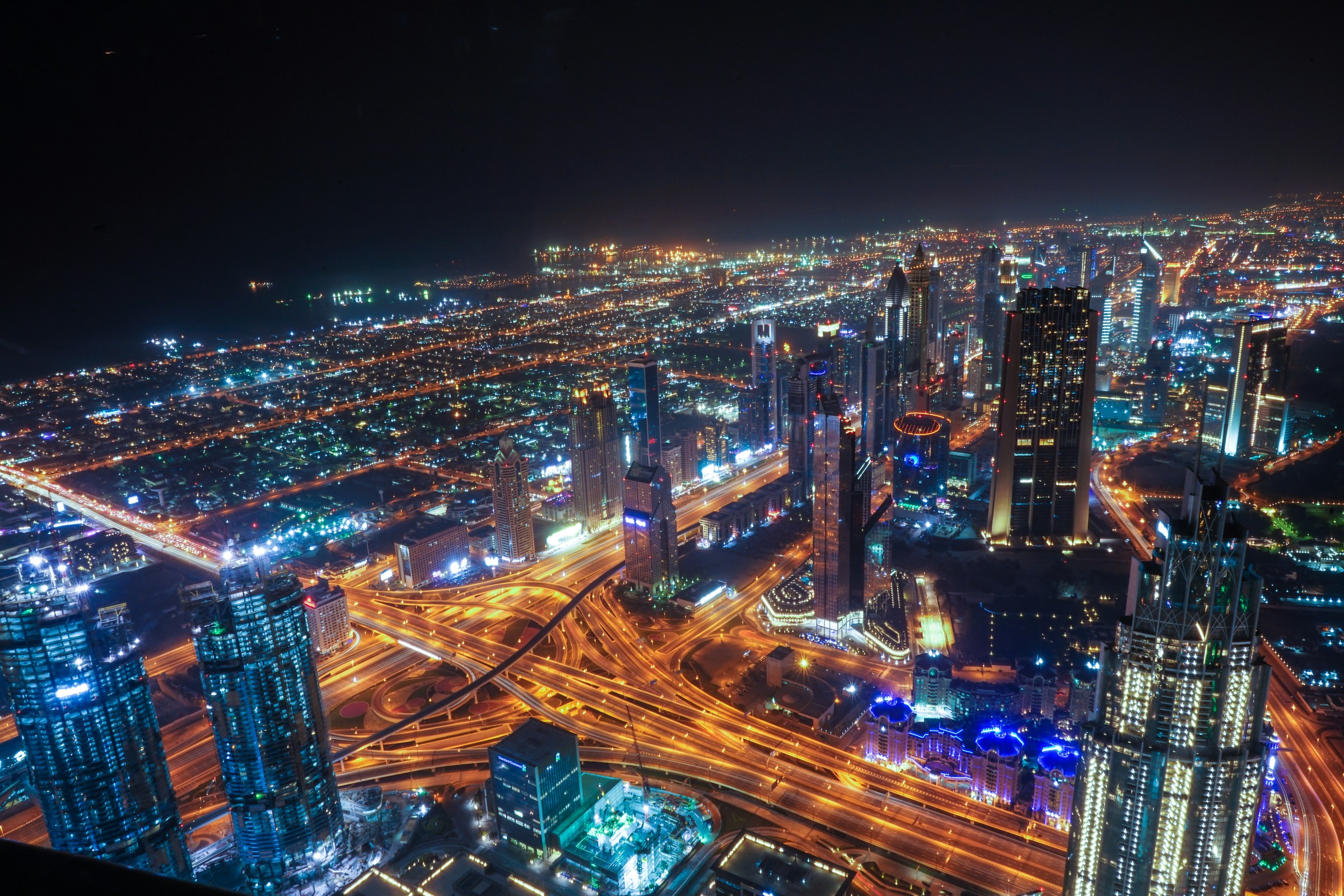 Illuminated city towers and interconnecting roads at night