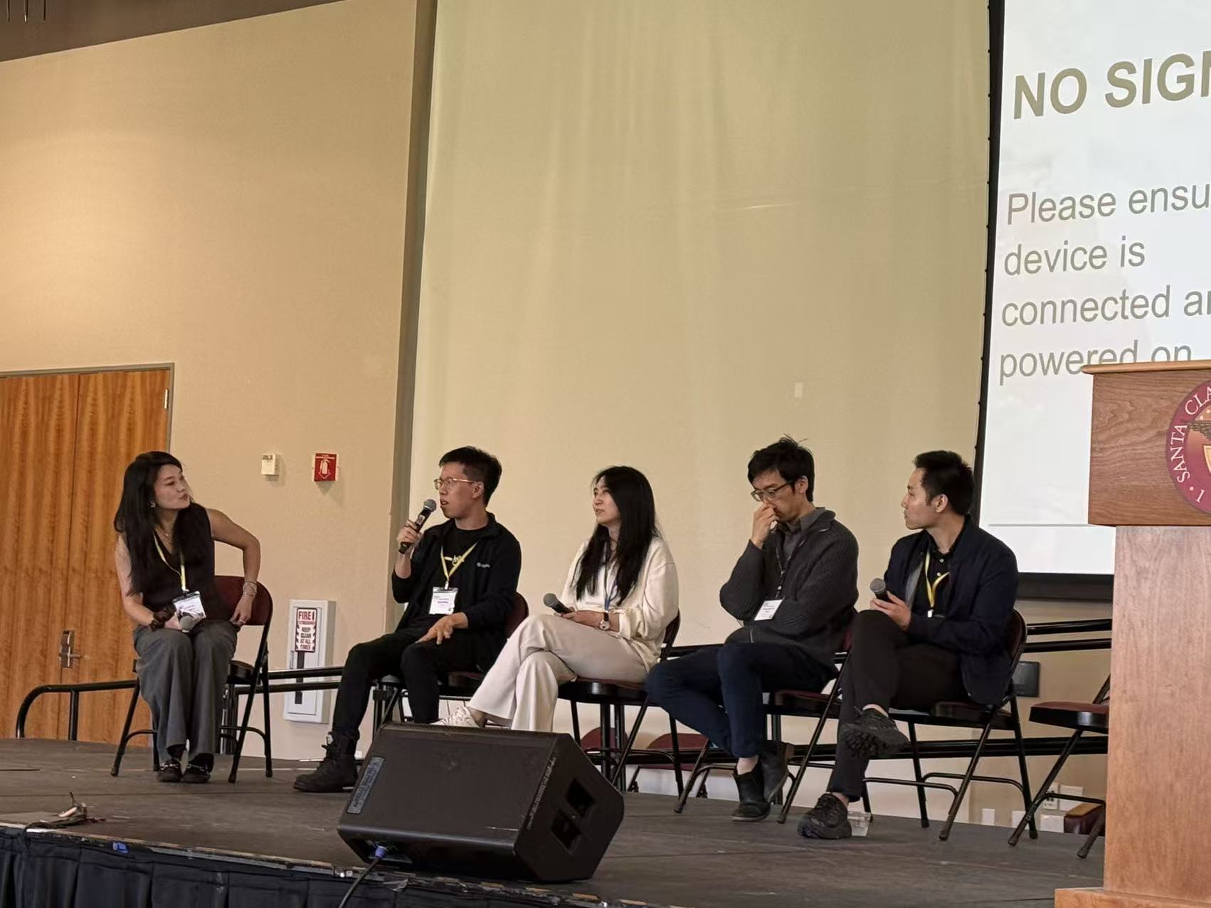 Panelists in conversation on stage at the 2026 ACSIC Symposium on Frontiers in Computing.
