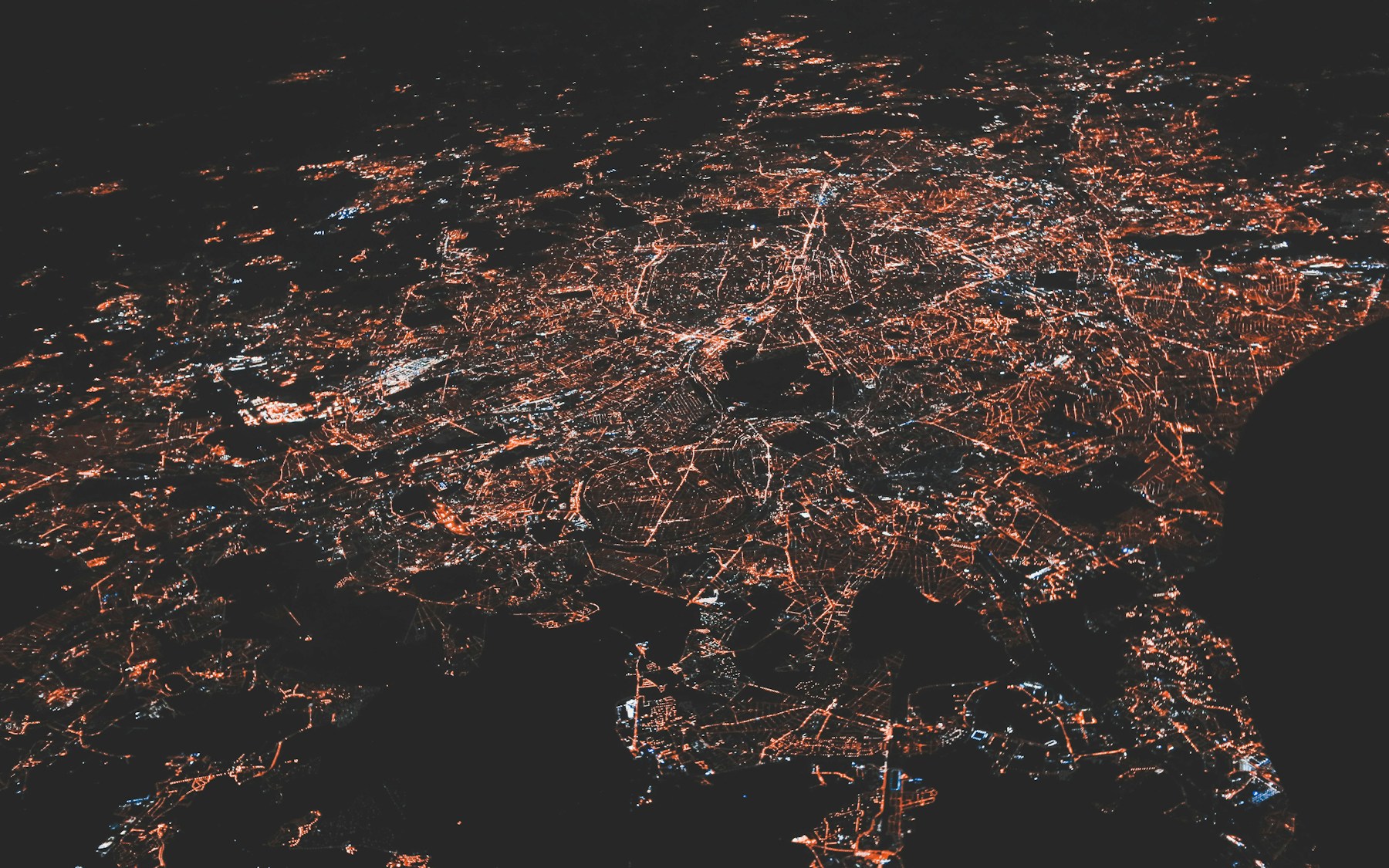 City lights tracing a connected regional network at night